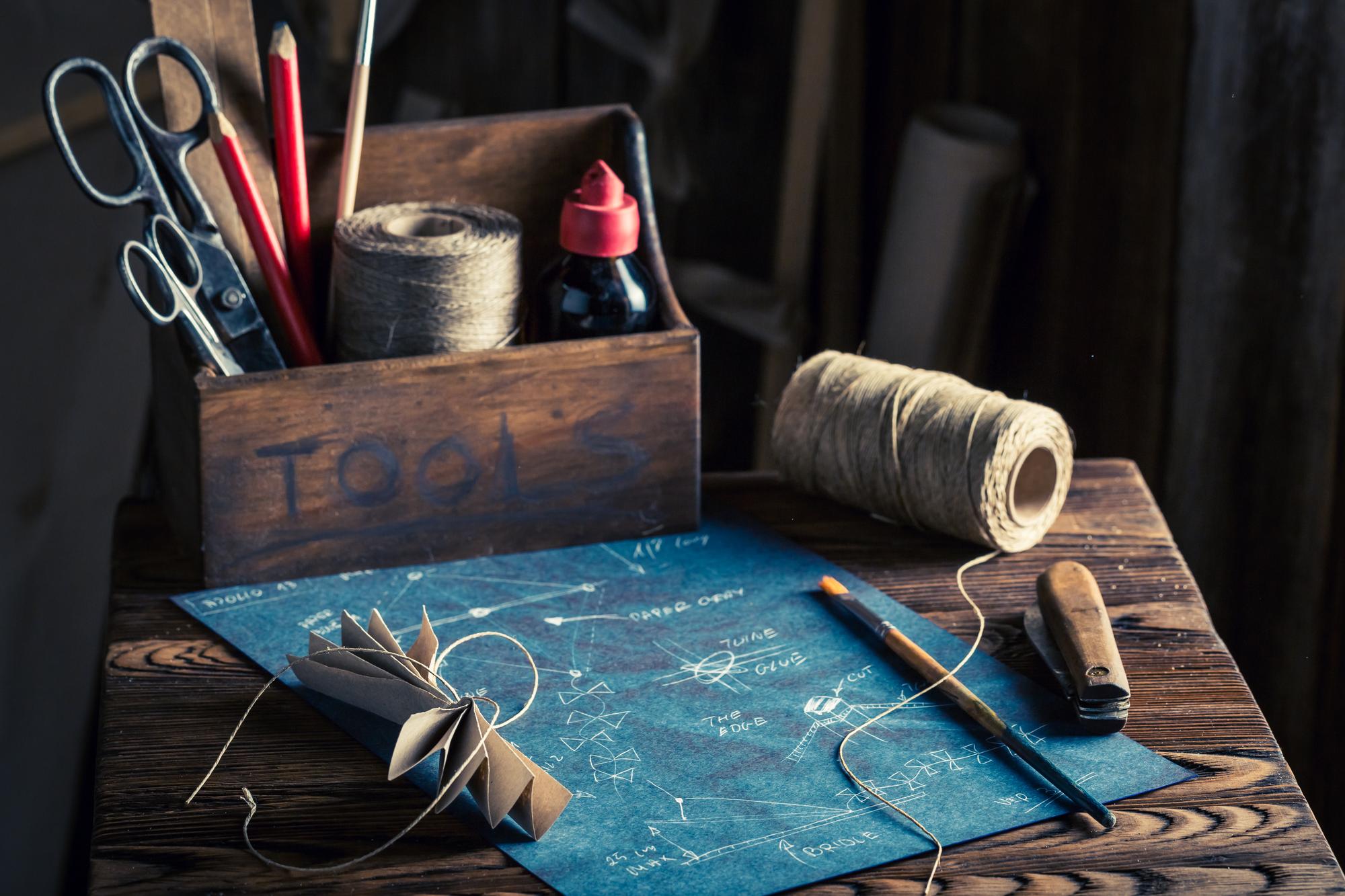 Workshop table with threads and needle, artisan hands