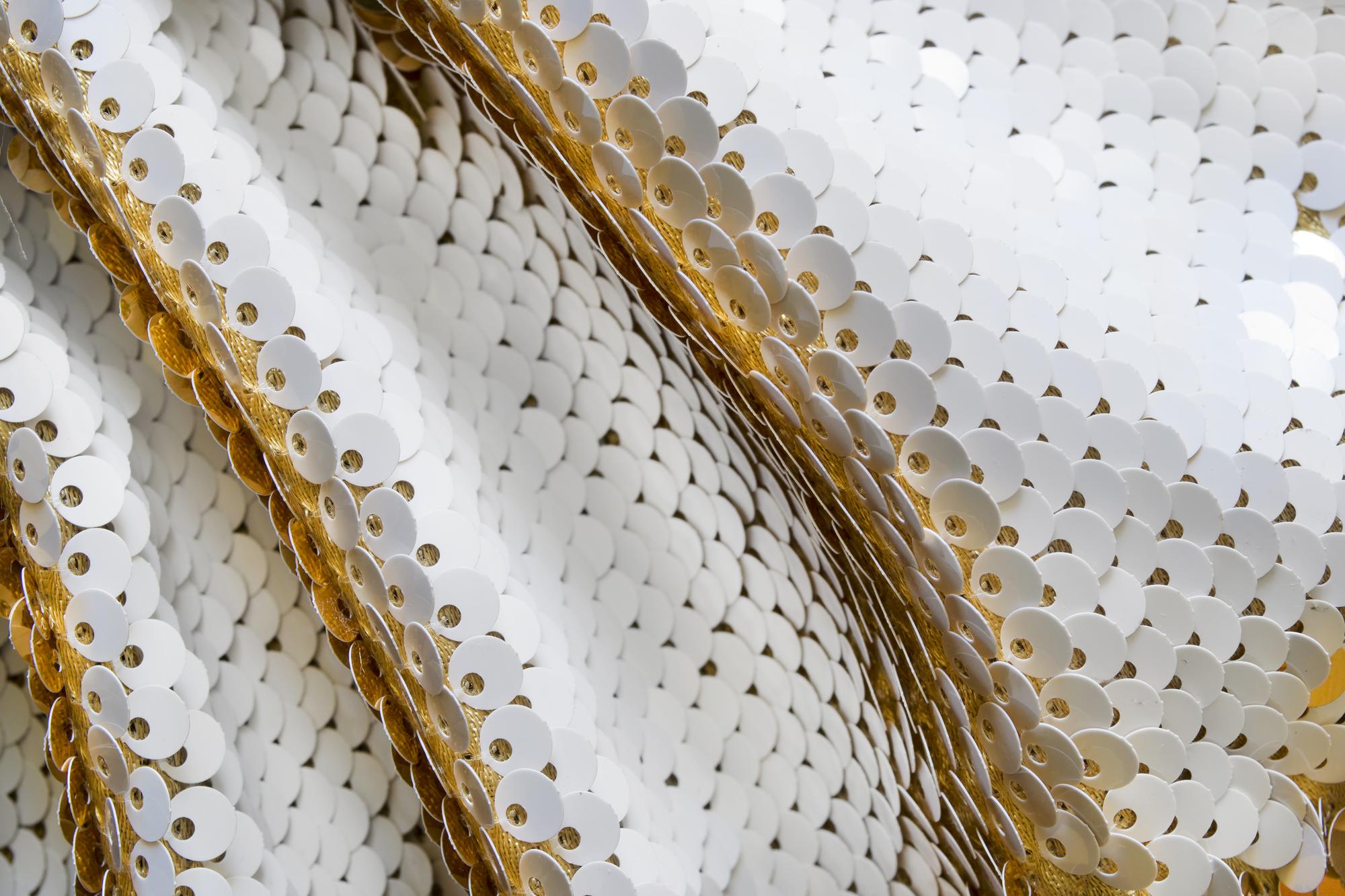 Close-up gold thread motif on linen